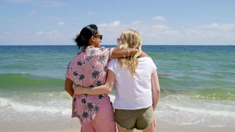 Back view of girlfriends enjoying idyllic, paradise summer vacation Stock Footage 220819612