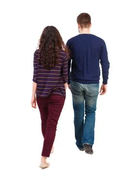 Back view going couple. walking friendly girl and guy holding h Stock Photos
