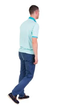 Back view of going  handsome man in jeans and a shirt Stock-Fotos