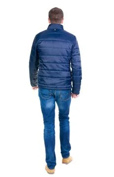 Back view of going  handsome man in jeans and jacket Stock-Fotos
