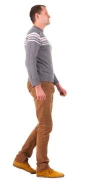 Back view of going   man in sweater and brown jeans Stock Photos