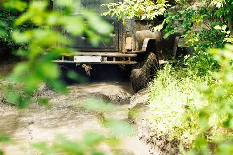 Back view of green russian off-road utility vehicle UAZ Hunter going up dirty Stock Photos