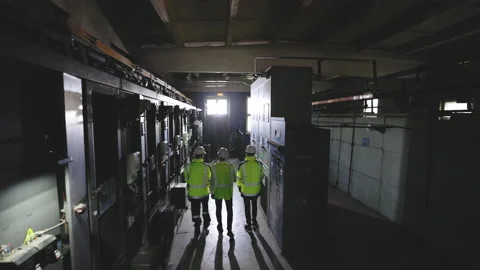 Back view of group multiethnic team of industrial engineers walking in Stock Footage 194614654