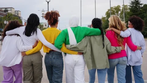 Back view of group young only female friends strolling embracing relaxed Stock Footage 276672173