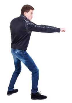 Back view of guy funny fights waving his arms and legs Foto stock