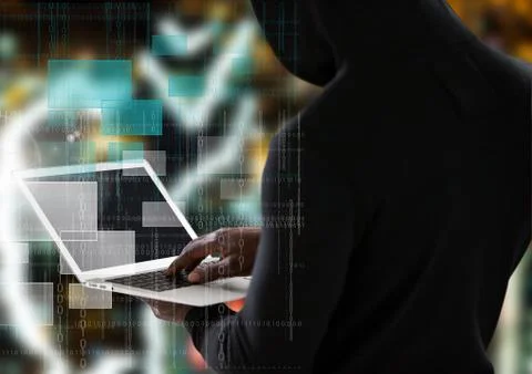 Back view of hacker using a laptop Stock Photos