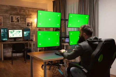 Back view of hackers in front of computer Stock Photos