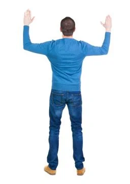 Back view of handsome man in blue pullover  looking up Stock Photos