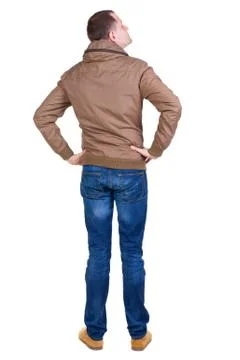 Back view of handsome man in brown windcheater looking up Stock Photos
