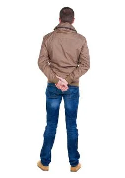 Back view of handsome man in brown windcheater looking up Stock Photos
