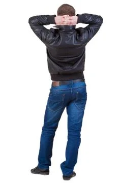 Back view of handsome man in jacket relaxed looks into the dista Stock-Fotos