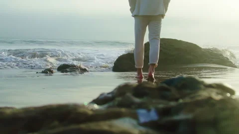 Back view. Handsome man in white suit walking by Pacific Ocean Stock Footage 245952661