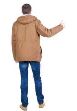 Back view of handsome man in winter jacket  shows thumbs up Stock Photos