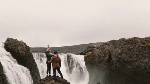 Back view of happy couple after hiking. Traveling man and woman stand near the Stock Footage 82986258
