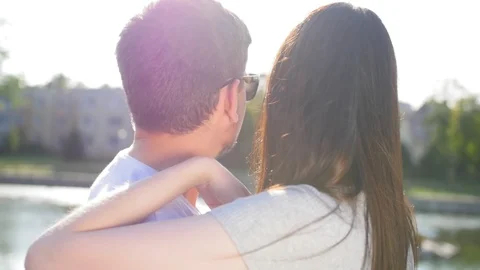 Back view of happy couple standing and looking into the pond, outdoor. Couple Stock Footage 116671151