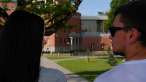 Back view of happy couple walking outdoor and talking together in park. Couple Stock Footage 116663679