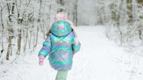 Back view happy cute child girl in a colorful clothing and hat running in a Stock Footage 194740043