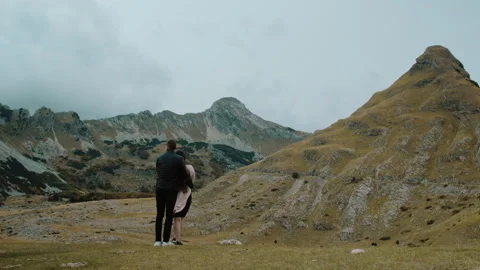 Back view of  happy lover in wild nature, young couple standing Stock Footage 130373140