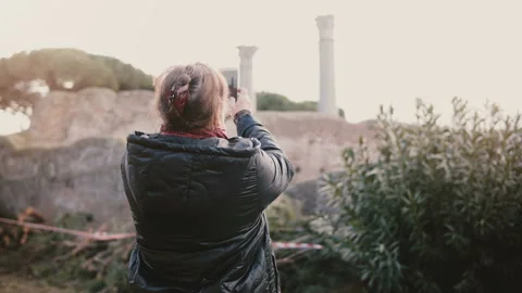 Back view of happy senior smiling Caucasian woman taking a smartphone photo of Stock Footage 94985919