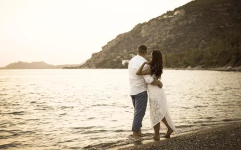 Back view of happy young couple on the beach Stock-Fotos