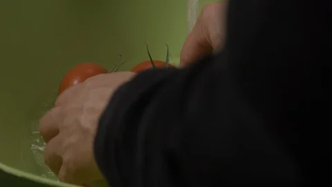 Back view-hotel chef washing Italian tomatoes in a green bowl 4k Stock Footage 96193374