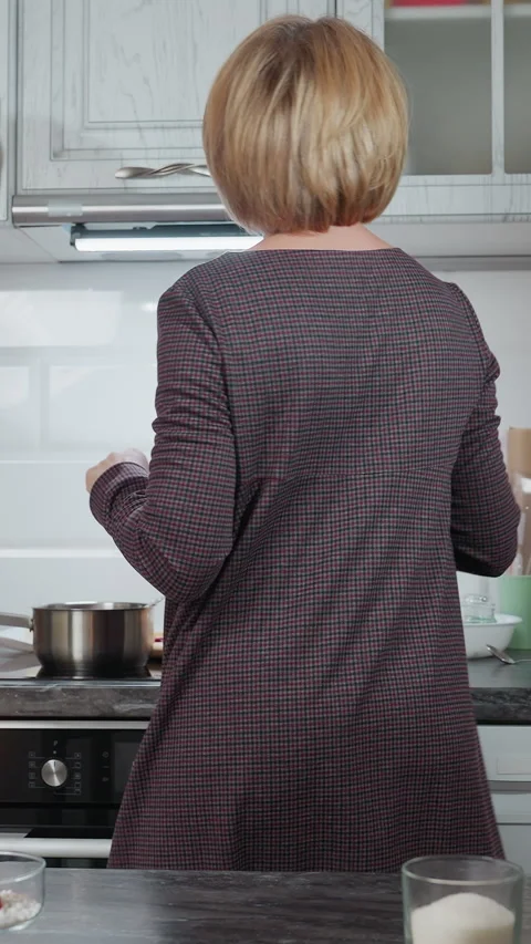Back View of House Owner Dancing in Cozy Modern Kitchen with Candlelight Видео 320374730
