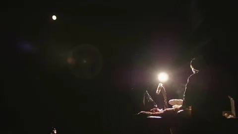 Back view of hunter dressing waterflow surrounded by flies. Backlit. Stock Footage 124048860