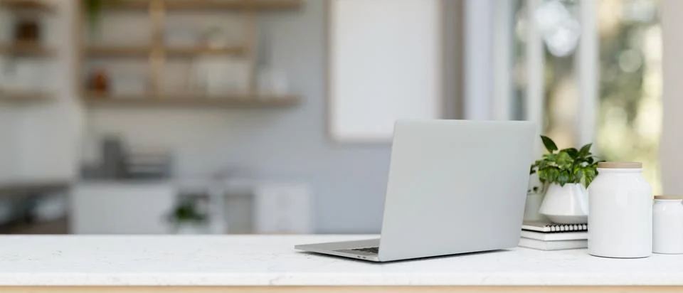 A back view image of a laptop computer and decor on a white table in a mode.. Stock Illustration
