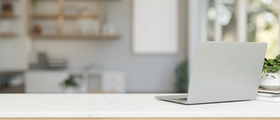 A back view image of a laptop computer on a white tabletop in a contemporar.. Stock Photos