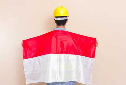Back view of Indonesian construction worker wearing yellow hard hat and saf.. Stock Photos