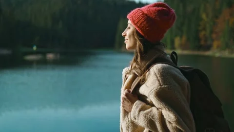 Back view inspired joyful woman hiker sits on wooden pier at beautiful mountain Stock Footage 167201700