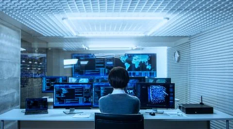 Back View of the IT Engineer Working with Multiple Monitors Showing Graphics, Stock Photos