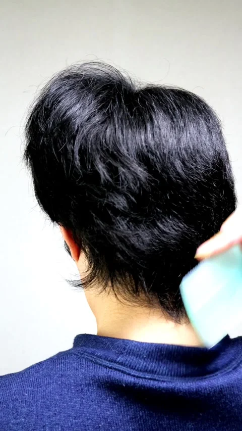 The back view of a Japanese man combing his hair. Stock Footage 336235461