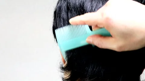 The back view of a Japanese man combing his hair. Stock Footage 336240820