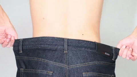 The back view of a Japanese man who successfully lost weight. Video stock 336679643