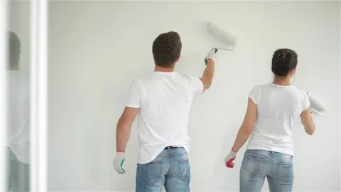 Back View of Joyful Couple Doing Apartment Repair Together. Young Wife and Stock Footage 80968240