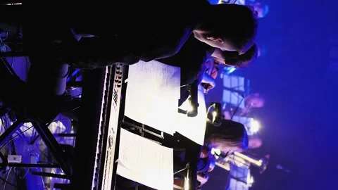 Back view of a keyboard player who sits behind violinists at a concert. Close-up Stock Footage 254051192
