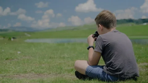Back view of kid boy drinking herbal tea from thermo cup enjoying vacation Stock Footage 138739025