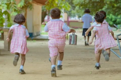 Back view of Kindergarten students run back to the classroom after having lun Stock Photos