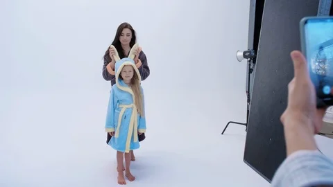 Back view of lady with photo camera taking pictures of cheerful mother and 스톡 동영상 122438537