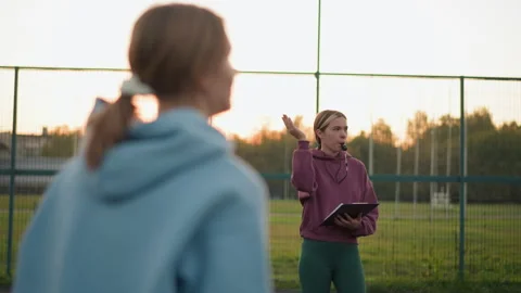 Back View of Lady Practicing Volleyball with Coach Taking Notes Holding Whistle Vidéo 304996286