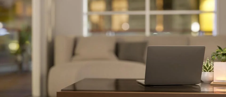 A back view of a laptop on a coffee table in a cozy, contemporary living room Foto stock