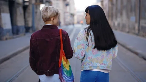 Back view of the lesbian couple walking , spending time together, talking Stock Footage 212731690