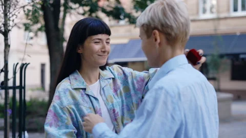 Back view of the lesbian partner is doing proposal. Young homosexual female gay Stock Footage 211351009