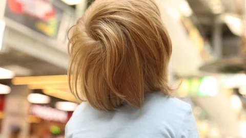 Back view of little blonde boy in modern shopping center mall excited baby 스톡 동영상 113323385