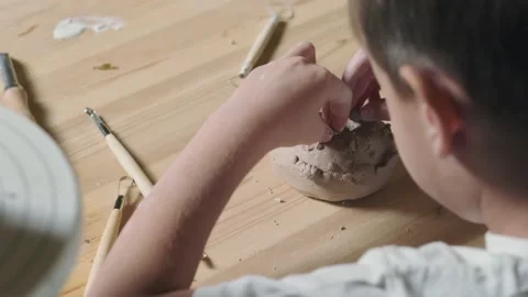 Back view of little boy plays with clay in pottery class Video stock 143618636