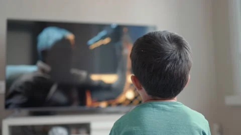 Back view of little boy watching movie on TV at home Stock Footage 187049838
