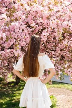 Back View of the Long Haired Drunette Lady in White Dress Standing and Posing on Stock Photos