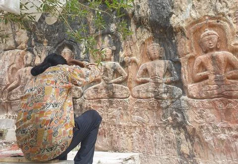 Back view of a long haired man taking photo of Gyalwa Ringna 5 Dhyani Buddha  Stock Photos
