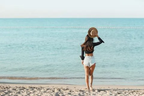 Back view of long haired young woman in swimsuit Stock Photos